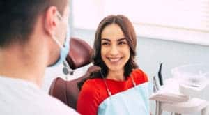 women smiling at dentist